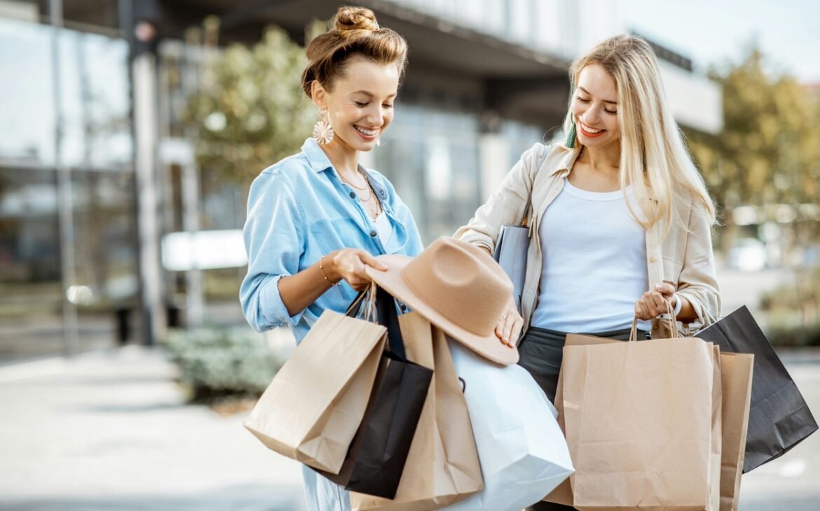 Two happy girls looking at their purchase.