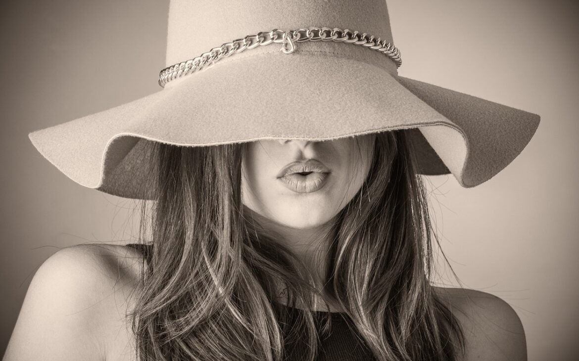 Black and white photo of woman in hat.