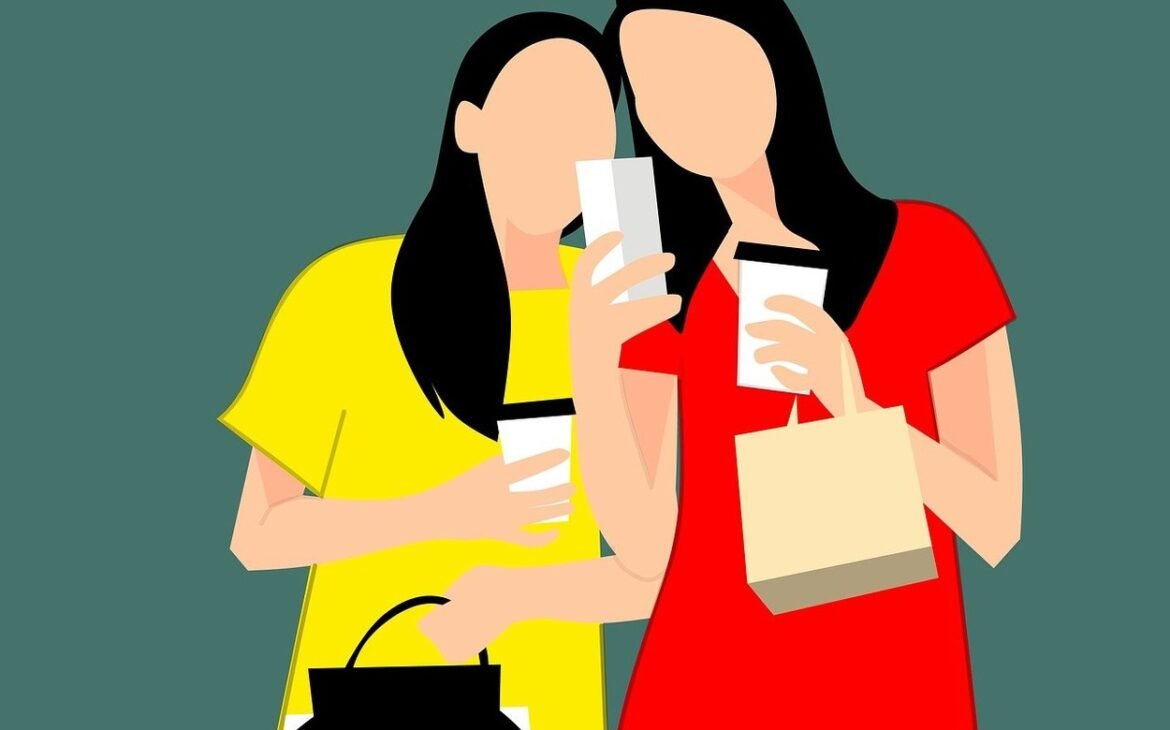 Two girls enjoying shopping time with coffee and phone in hand.